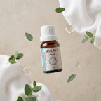 Miraya essential oil bottle with eucalyptus leaves on a beige background