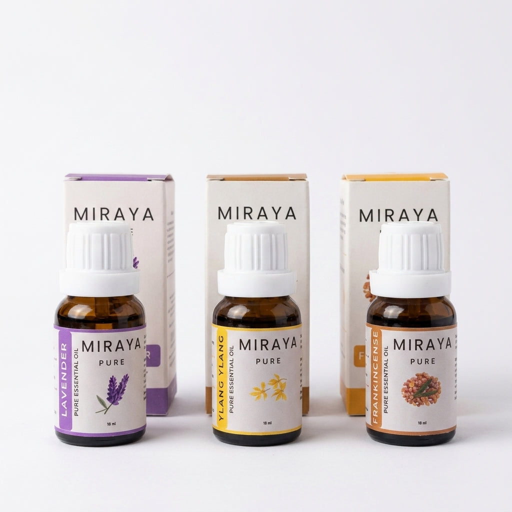 Three Miraya essential oil bottles with their packaging on a white background