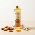 Bottle of Miraya Sweet Almond Oil with almonds and flowers on a light background